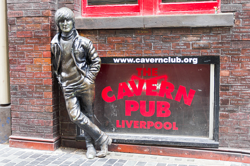 Liverpool, England- April 3, 2017: John Lennon statue in front of the Cavern Pub. The sculpture was unveiled on 16 January 1997 outside the pub, located in front of the Cavern Club.