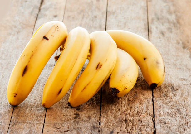 istock banana bunch on Wooden background 670869810