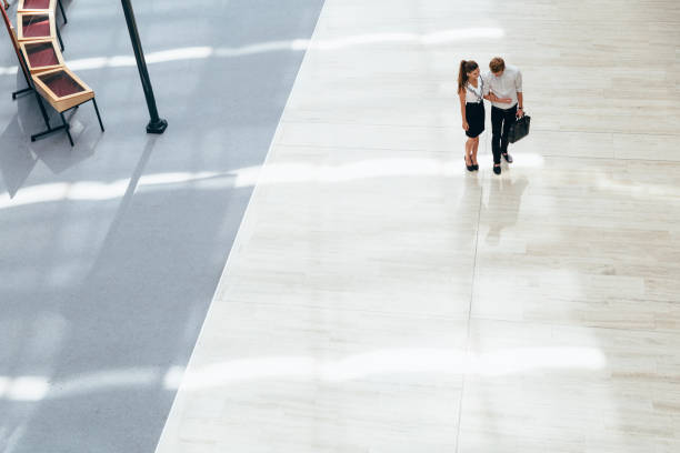 istock Business couple walking together. Top view 670871140