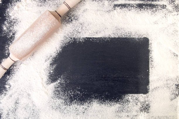 istock Copy space around rolling pin and flour on black background. Top view. Frame. 670877140