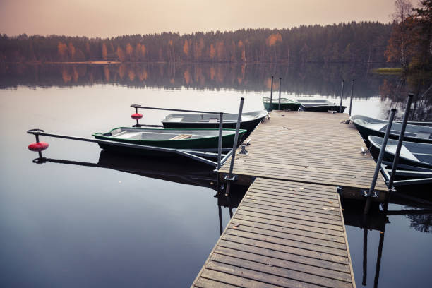 istock Floating pier with moored row boats, still lake 670879422
