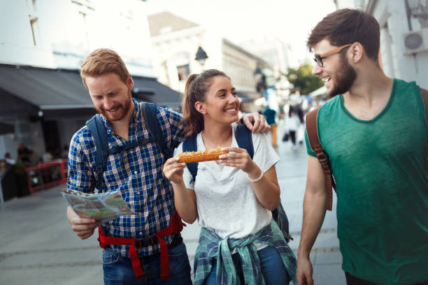 istock Young travelling people having fun and sightseeing  in city 670879472