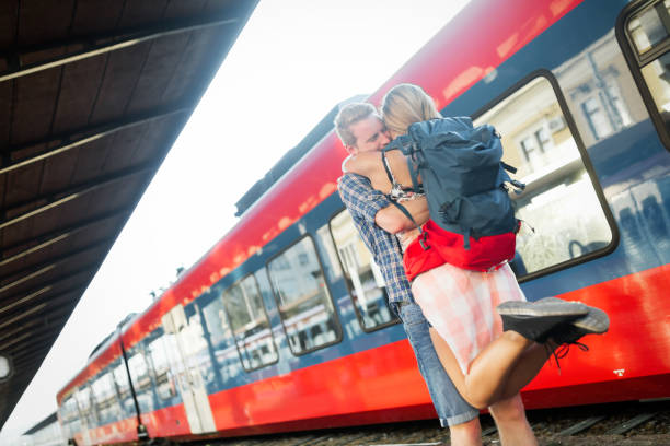 istock Beautiful couple reunion /separation at train station 670880410