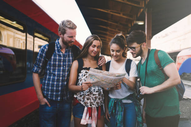 istock Young group of travelling tourists at train station 670880698