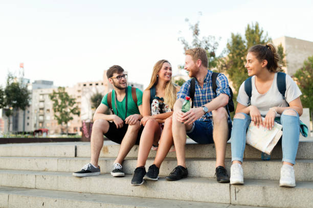 istock Young  cheerful students being happy at campus stairs 670880756