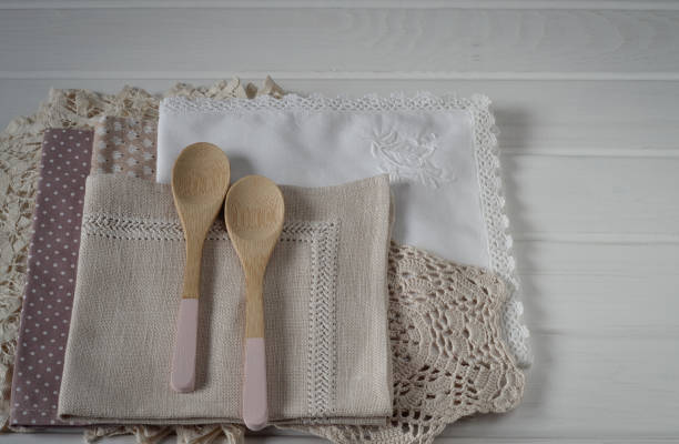 istock Different rustic linen napkin and wooden spoons on white background 670880806