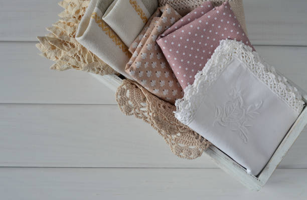 istock Different rustic linen napkin in white wooden box on white background 670880850