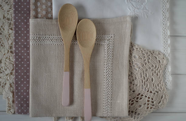 istock Different rustic linen napkin and wooden spoons on white background 670880858