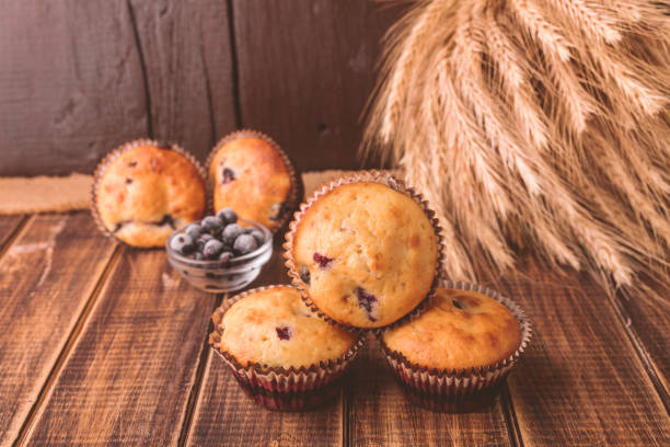istock Muffins on wooden background on rustic style. Cupcake with currant. 670887030