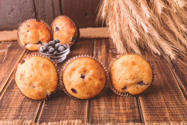 istock Muffins on wooden background on rustic style. Cupcake with currant. 670887040