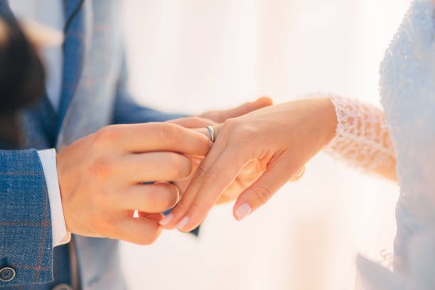 the newlyweds exchange rings at a wedding - engagement wedding wedding ceremony ring imagens e fotografias de stock