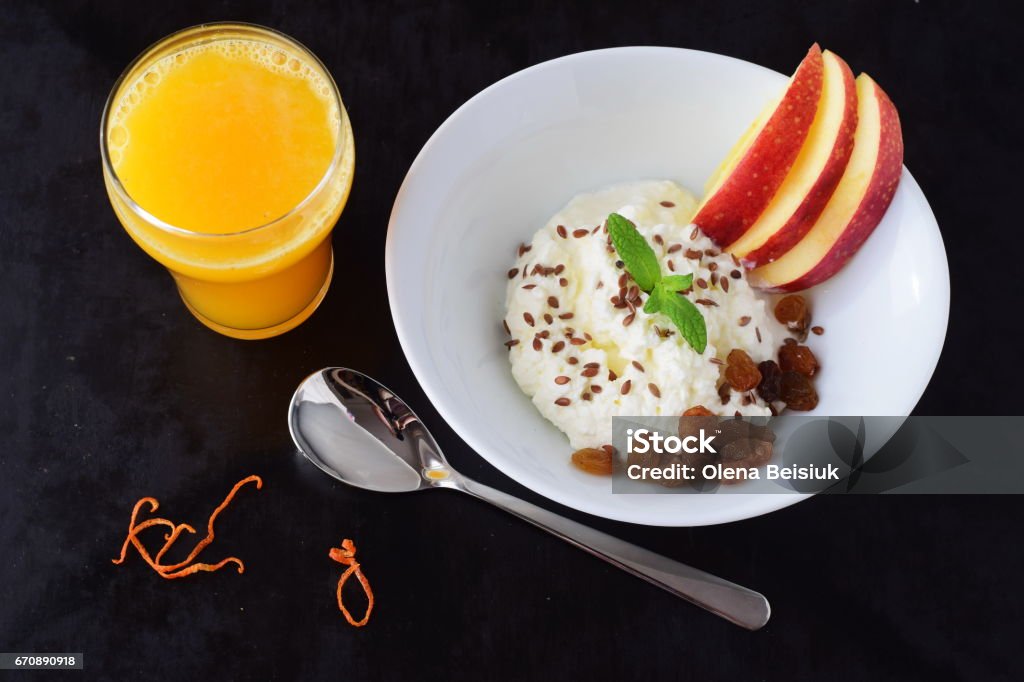 Healthy breakfast: cottage cheese with flax seeds, raisins, fresh apples and a glass of fresh orange juice. Healthy eating concept Australian Freshwater Crocodiles Stock Photo