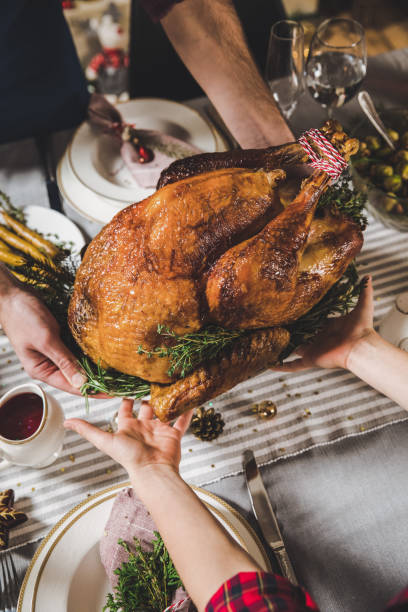 istock Father and son holding roasted turkey 670891356