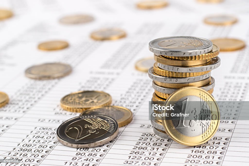 finance business euro stock background finance business accounting stock background with stack of euro coins on data sheet Euro Symbol Stock Photo