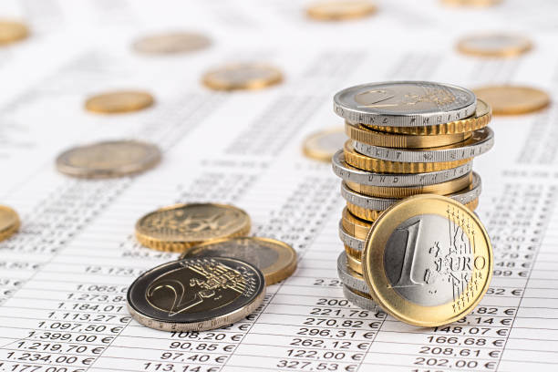 finance business euro stock background finance business accounting stock background with stack of euro coins on data sheet european union coin photos stock pictures, royalty-free photos & images