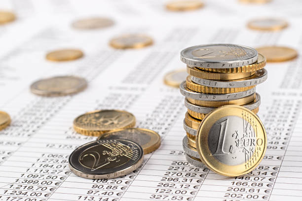 finance business euro stock background finance business accounting stock background with stack of euro coins on data sheet european currency stock pictures, royalty-free photos & images