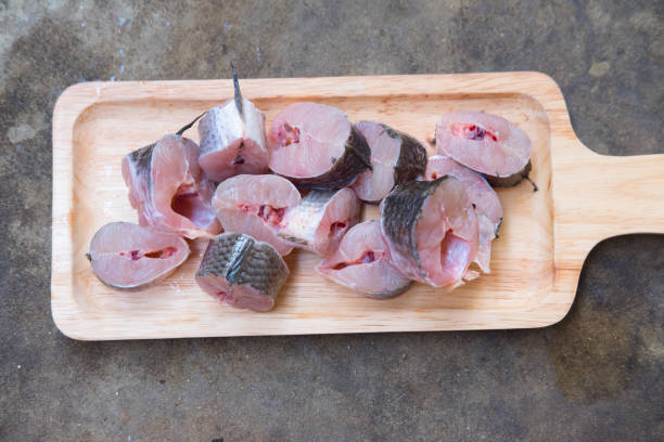Striped snakehead fish chopped preparing for cooking on wood tray