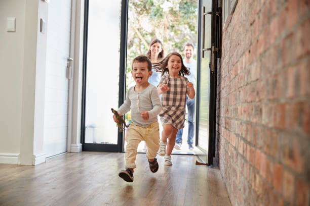 Excited Children Arriving Home With Parents Excited Children Arriving Home With Parents front door photos stock pictures, royalty-free photos & images