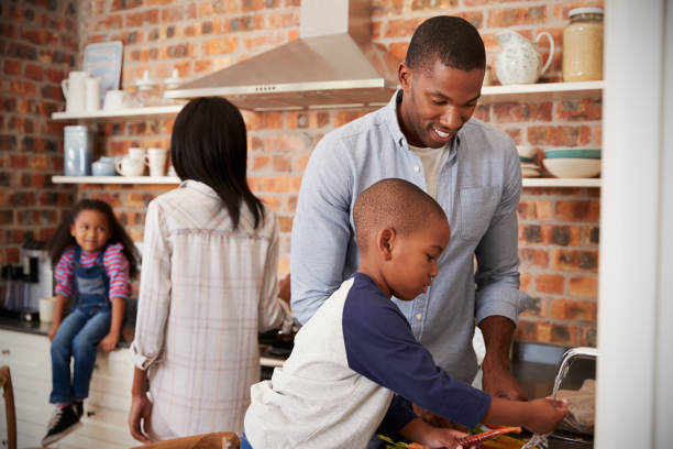 istock Children Helping Parents To Prepare Meal In Kitchen 670901012