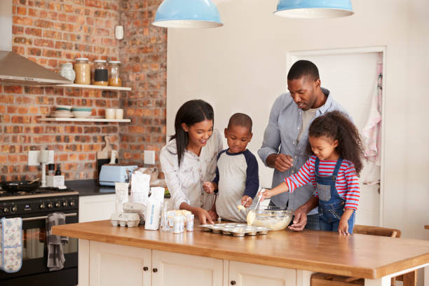 istock Parents And Children Baking Cakes In Kitchen Together 670901084