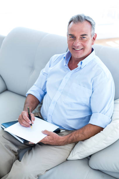istock Happy businessman writing on notepad  at office 670901992