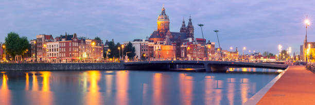 istock Night Amsterdam canal and Basilica Saint Nicholas 670902424