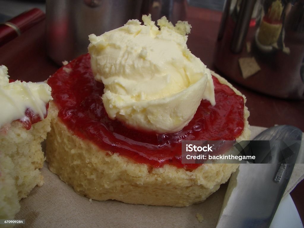 scone with jam and clotted cream - close up typical english / cornish part of afternoon tea is a freshly cooked scone with strawberry jam and clotted cream. Delicious but not recommended for a diet. Capital Cities Stock Photo