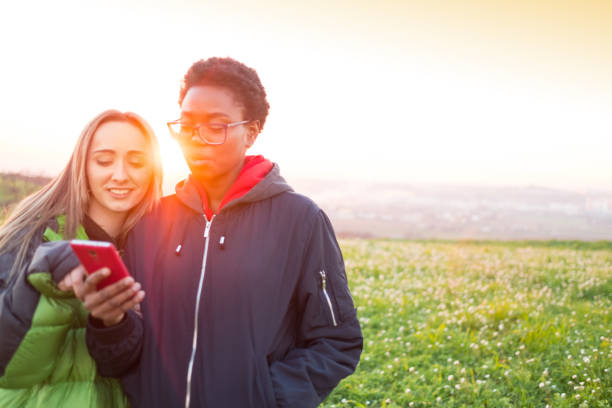 istock Best friends checking cellular phone 670910542