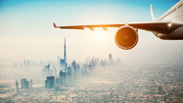 Close-up of commercial airplane flying over modern city stock photo