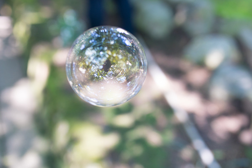 Photographer is in the soap bubble as a reflected image.