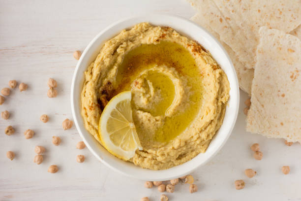 istock Hummus with spices and lemon in white bowl 670924416