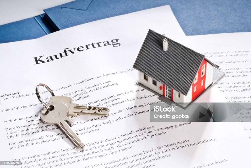 House with key and purchase contract Buying Stock Photo