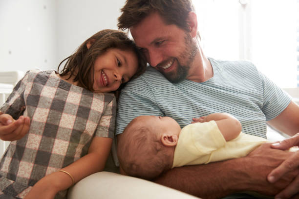 istock Father With Daughter And Newborn Son In Nursery 670930432