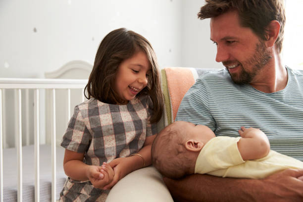 istock Father With Daughter And Newborn Son In Nursery 670930434