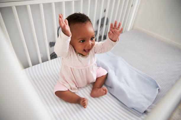istock Happy Baby Girl Playing In Nursery Cot 670930452