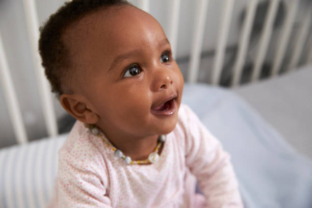 istock Happy Baby Girl Playing In Nursery Cot 670930468