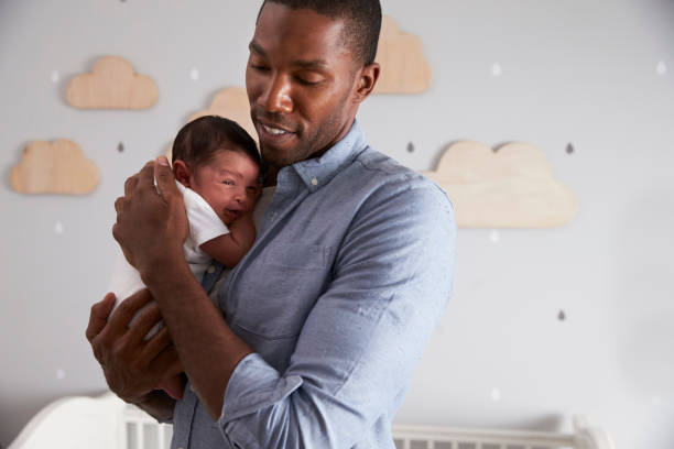 istock Father Holding Newborn Baby Son In Nursery 670930616