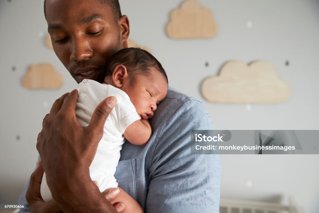 Father Holding Newborn Baby Son In Nursery Baby - Human Age Stock Photo