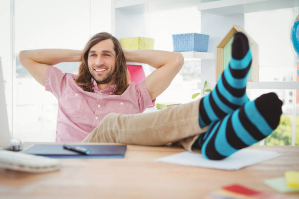 istock Hipster realaxing with legs on desk 670934660