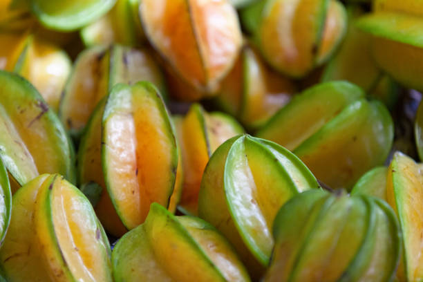 Full frame close up on a stack of Carambolas on a market stall.