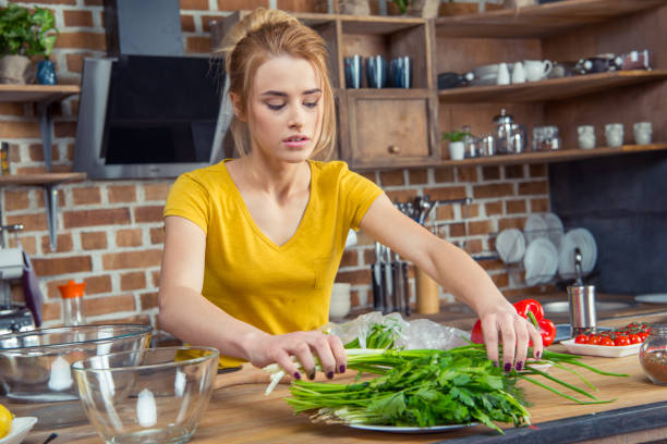 istock Woman holding green onions 670938584