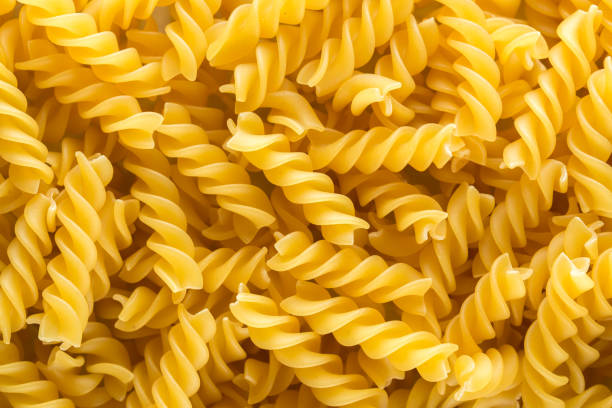 istock Italian fusilli pasta background 670942046
