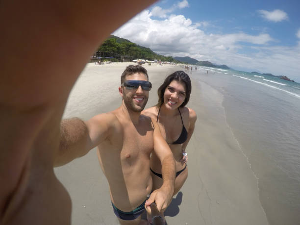 istock Couple taking a selfie in the beach 670947296