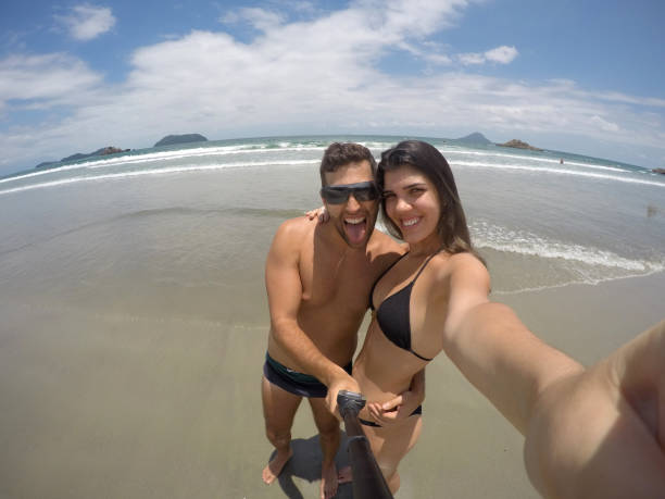 Couple taking a selfie in the beach