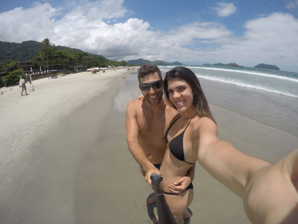 istock Couple taking a selfie in the beach 670947320
