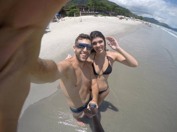istock Couple taking a selfie in the beach 670947348