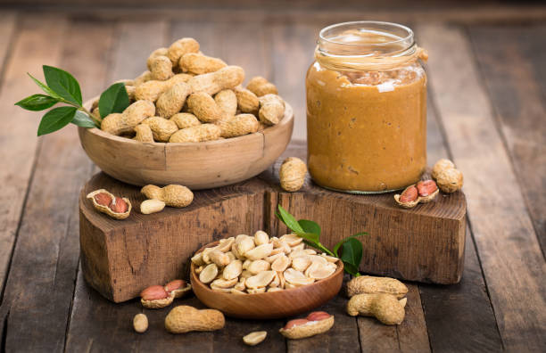 istock Peanut butter and peanuts on the wooden table 670950204
