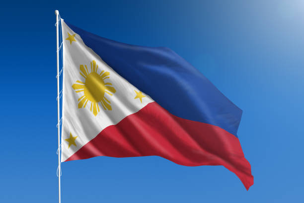 National flag of the Philippines on clear blue sky stock photo