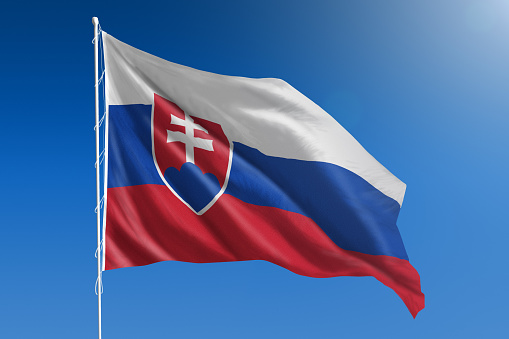 The National flag of Slovakia blowing in the wind in front of a clear blue sky