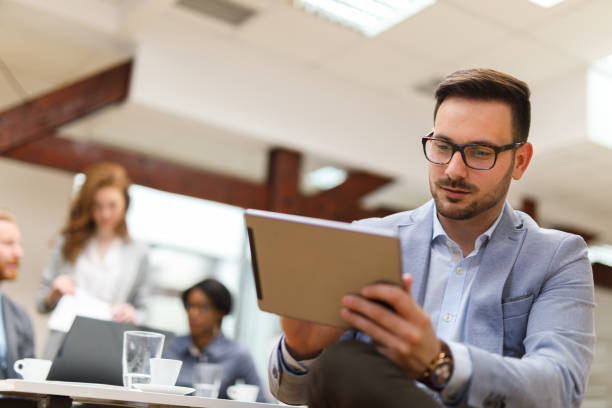 istock Young businessman using digital tablet and analyzing business report. 670954394